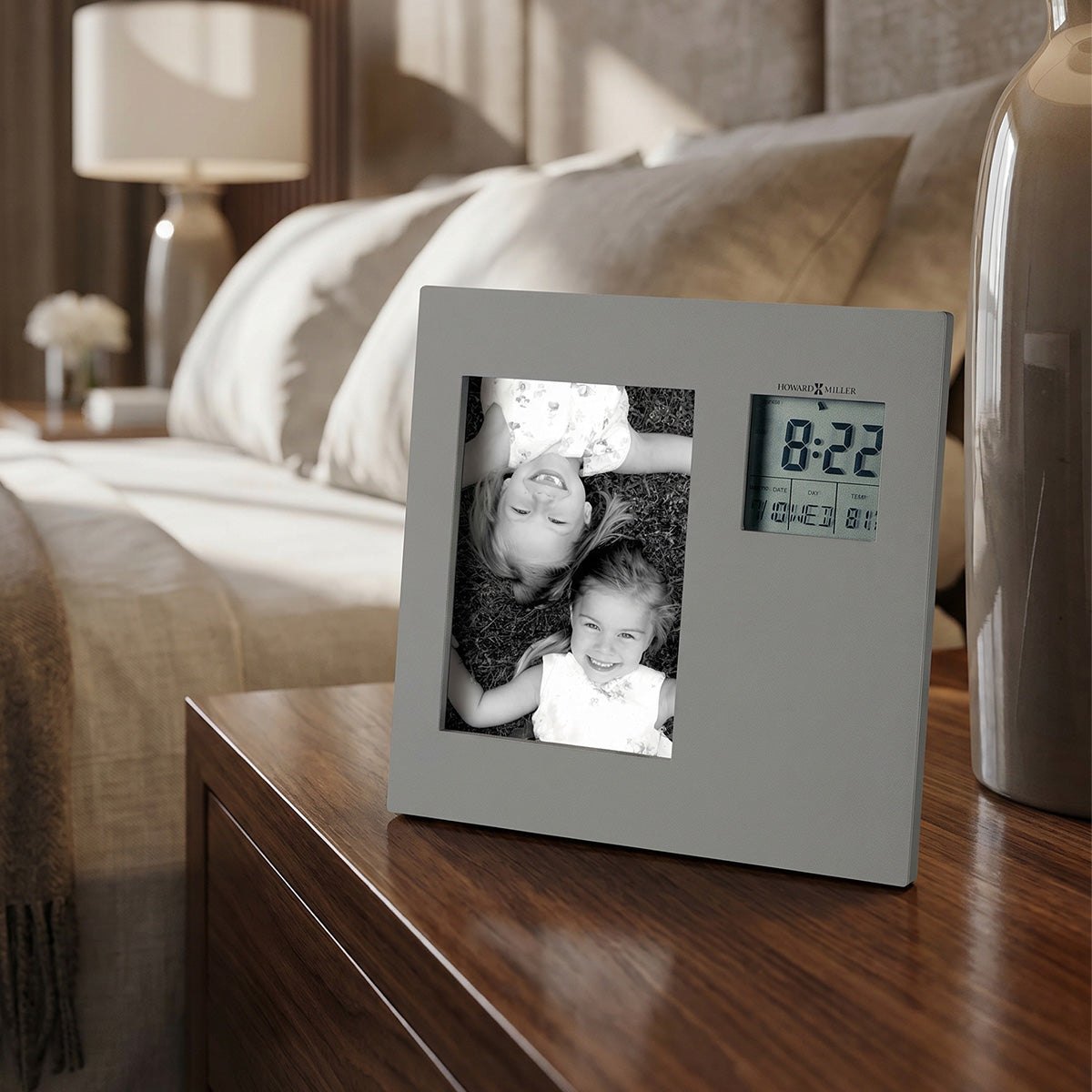 Digital photo frame with a clock on a wooden nightstand in a bedroom