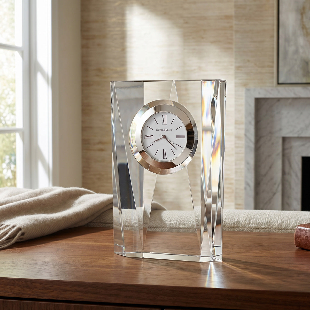 Decorative clock with a silver face and clear glass on a wooden surface.