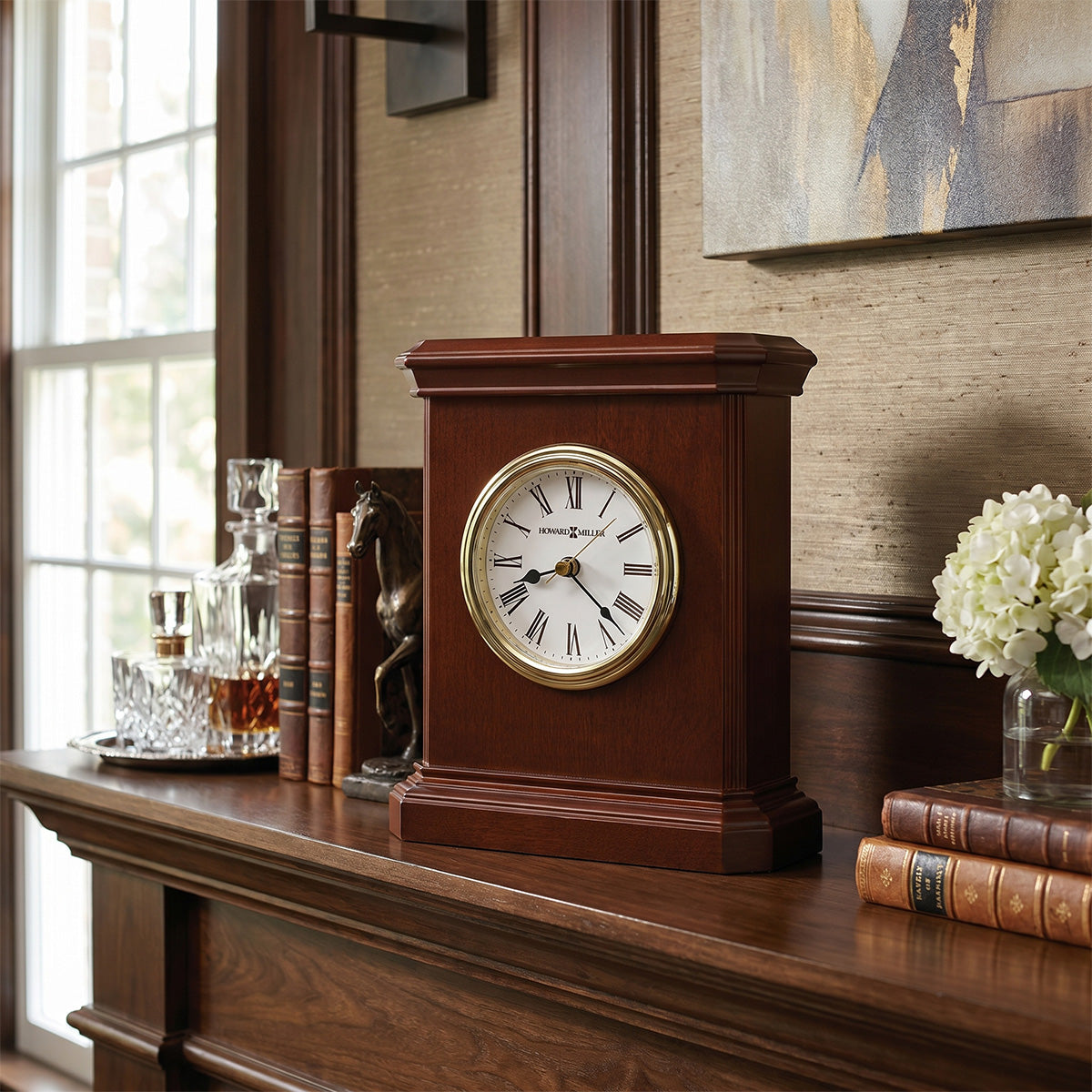 Wooden mantel clock on a wooden shelf with books and decorative items.