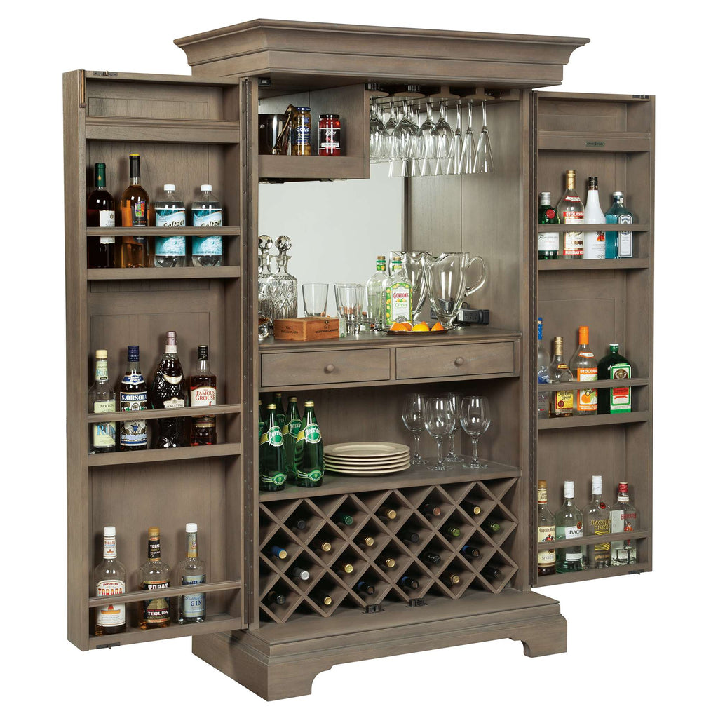 A stylish wooden bar cabinet with open doors, showcasing a variety of liquor bottles, glassware, and a wine rack.