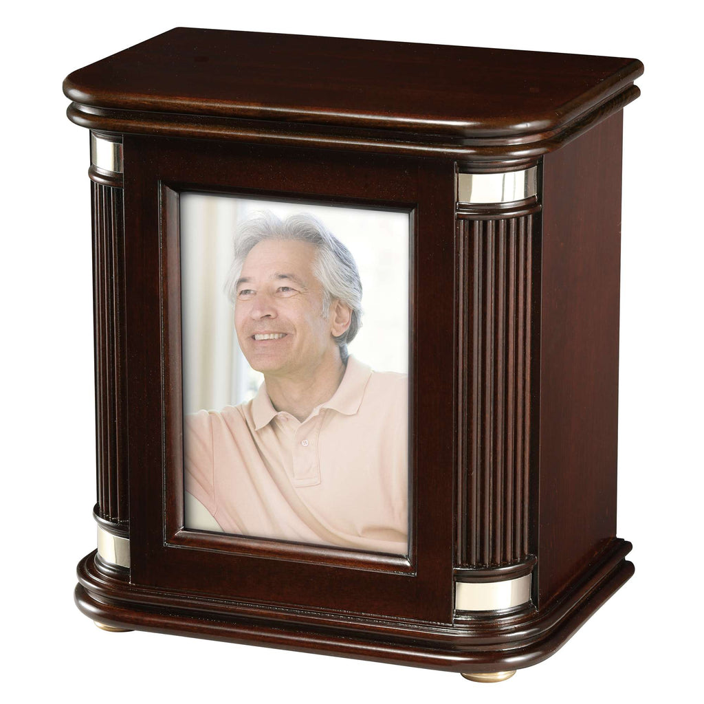 A wooden picture frame displaying a photo of a smiling older man.