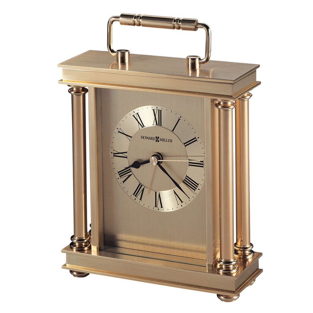 A classic brass table clock with Roman numerals and a handle.