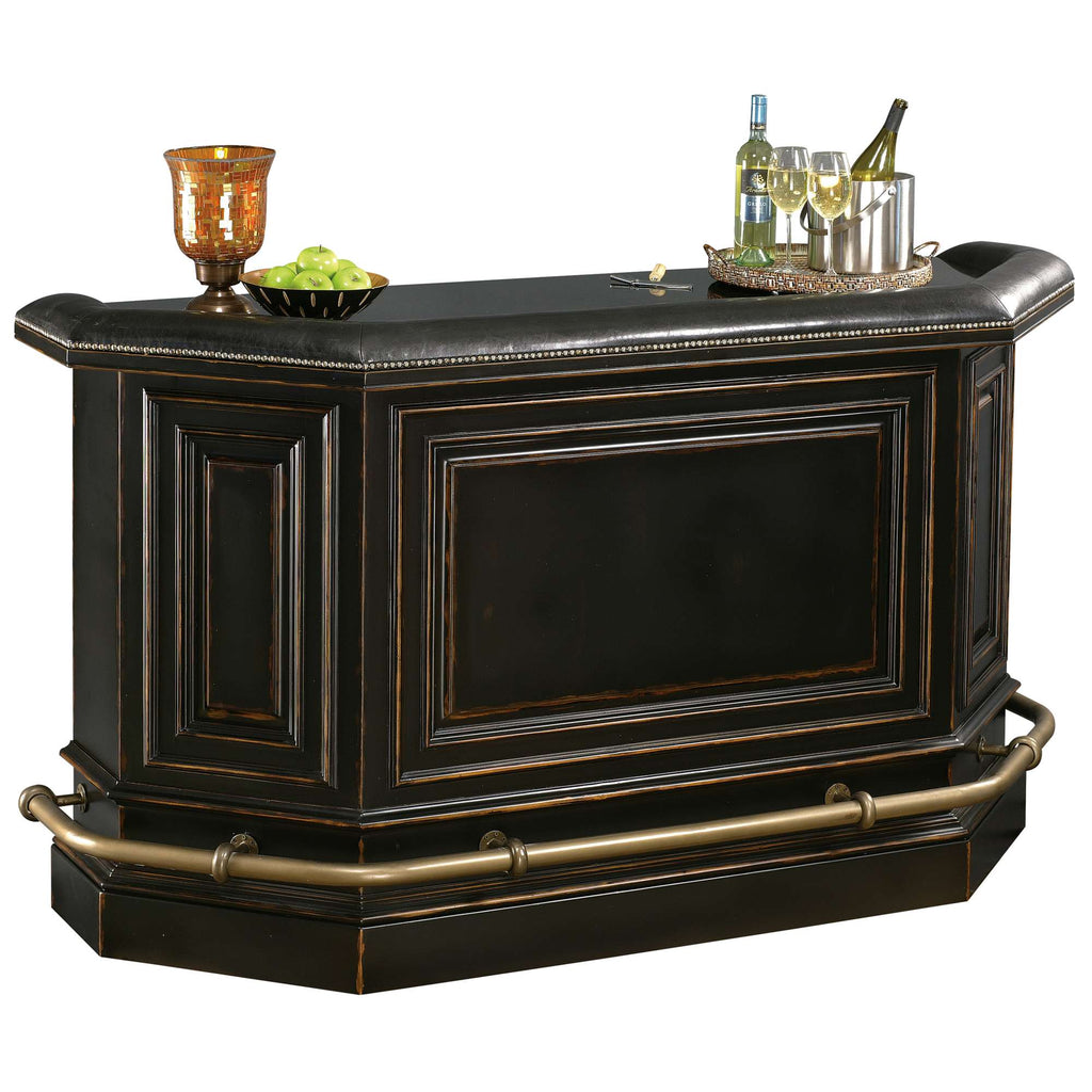 A stylish, dark wooden home bar with a polished countertop, decorative molding, and drinks on top.
