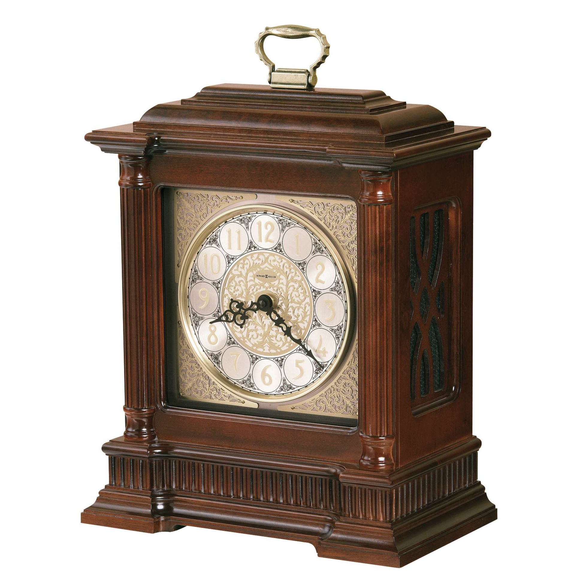 A vintage-style wooden mantel clock with a decorative face and gold accents.