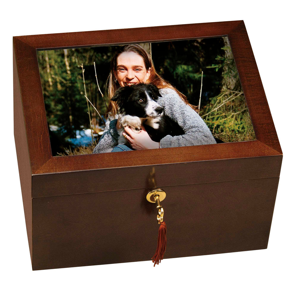 A decorative box with a photo of a woman holding a dog on the lid.