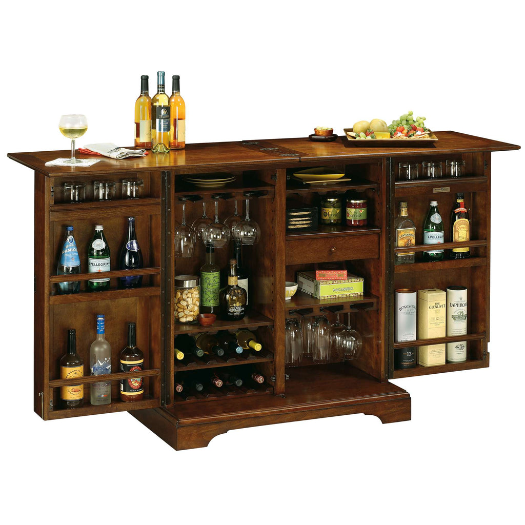 Wooden bar cabinet with various bottles, glasses, and snacks