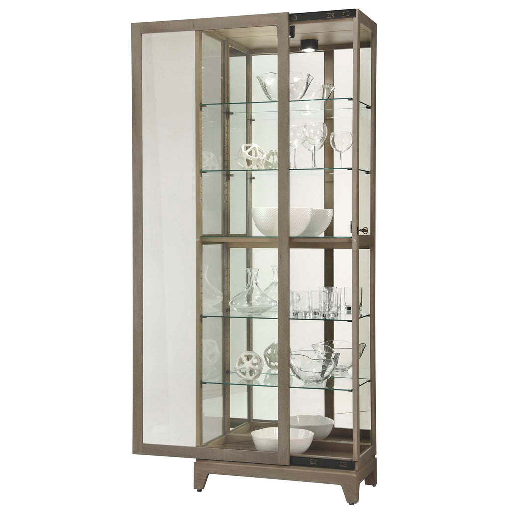 A tall glass display cabinet with multiple shelves showcasing various decorative glassware.
