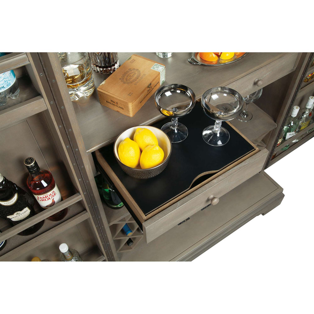 Bar cabinet with a drawer containing a bowl of lemons and two cocktail glasses