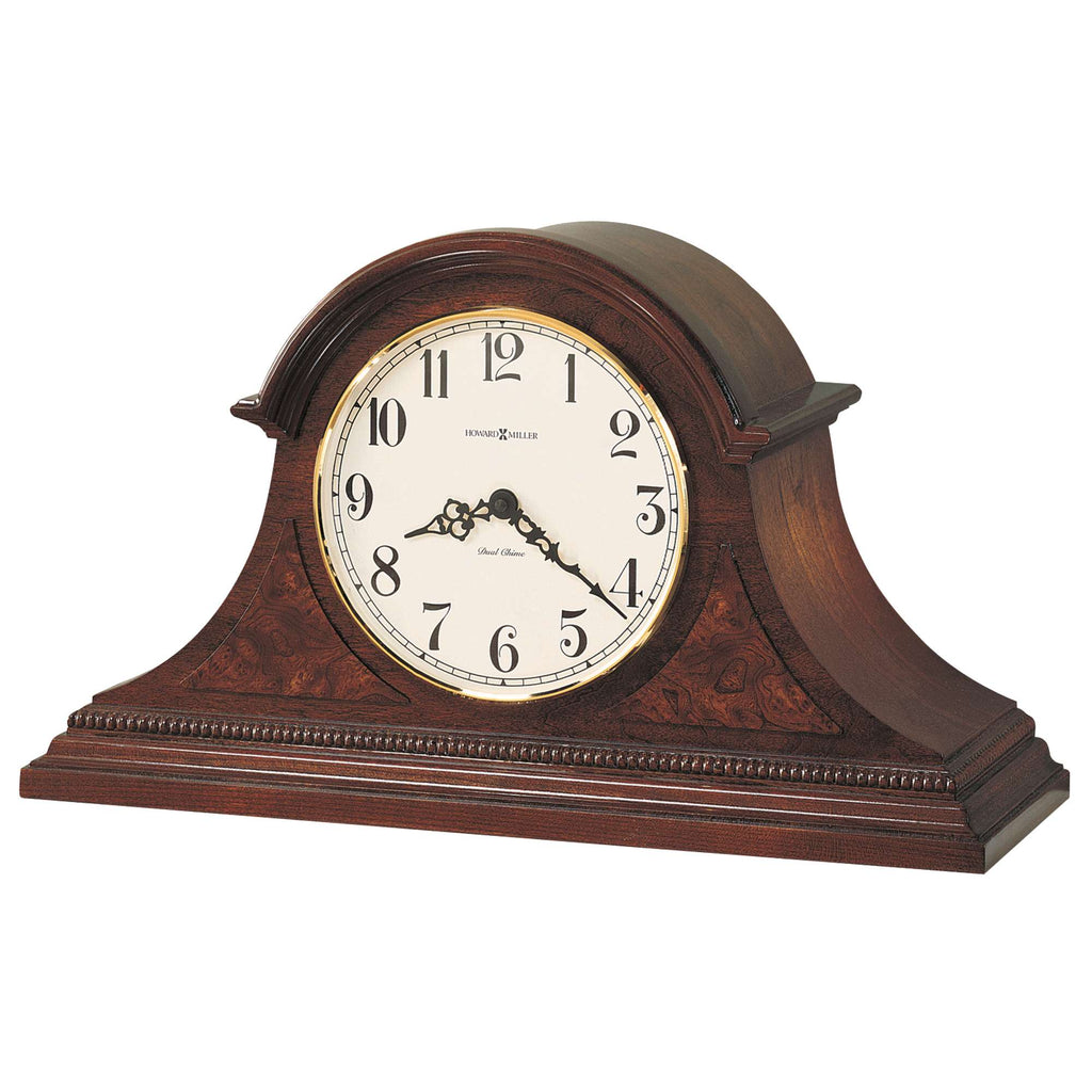 A classic wooden mantel clock with a round face and Roman numerals.