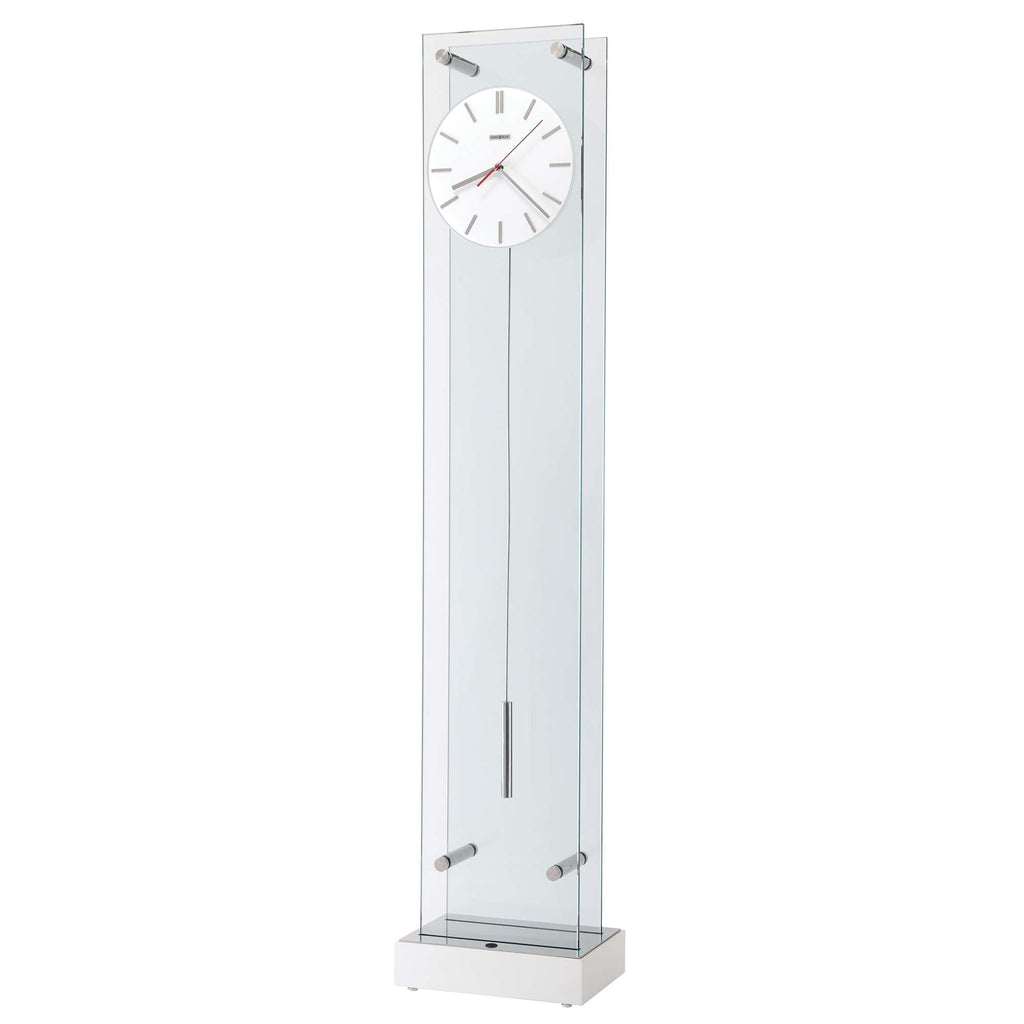 Tall glass wall clock with a white face and minimalistic design