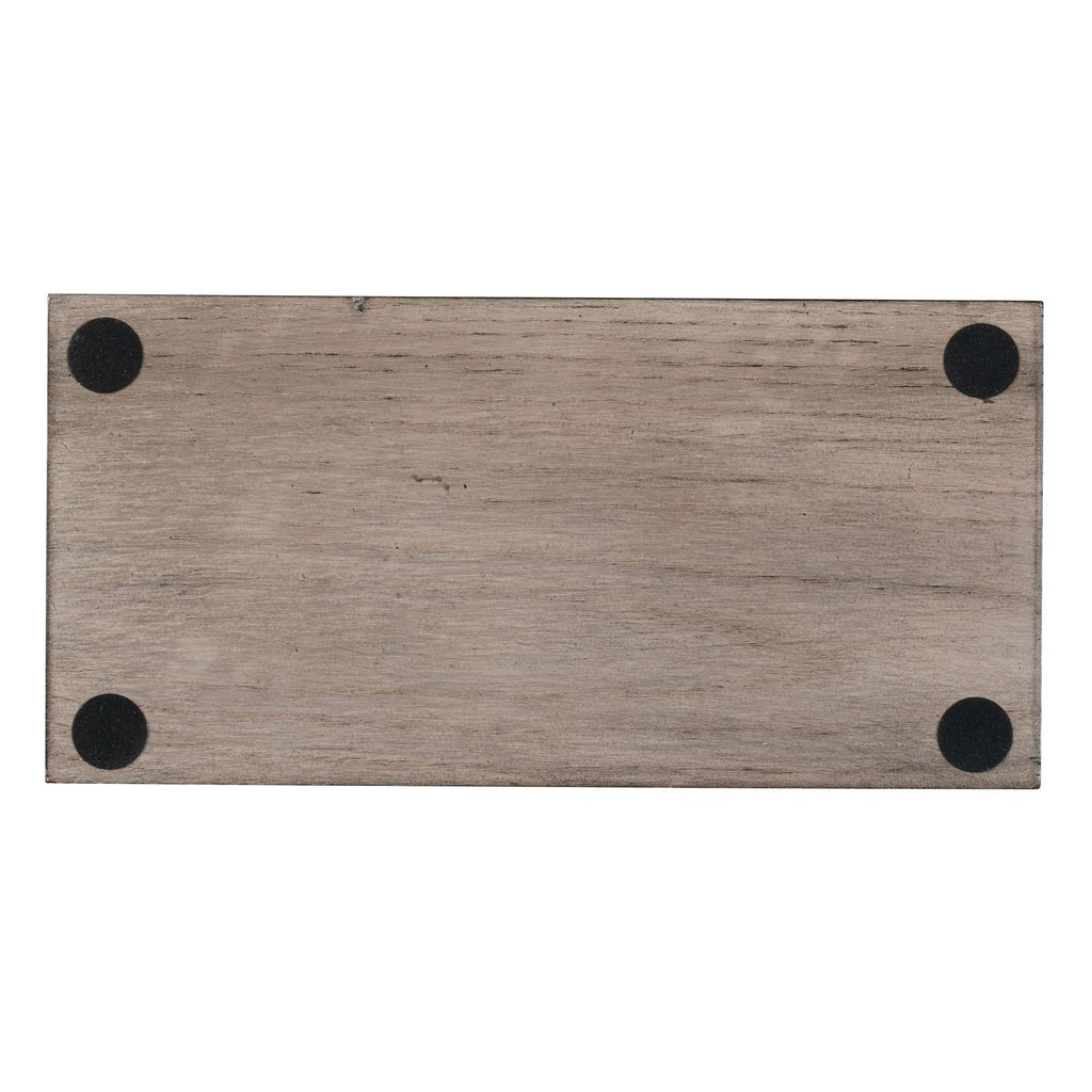 A rectangular wooden surface with four black circular feet at the corners.