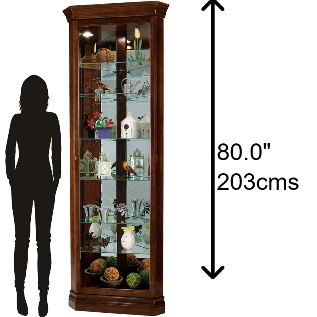 Tall glass display cabinet with various decorative items, next to a silhouette of a person for scale.