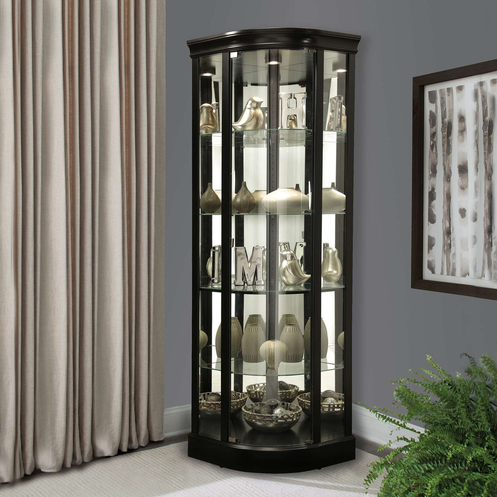 Curved display cabinet with glass shelves showcasing decorative items in a modern interior