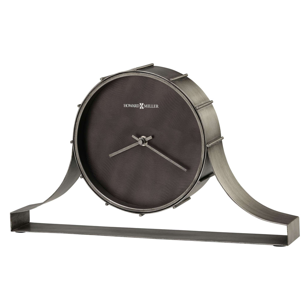 A stylish metal clock with a round face and curved stand