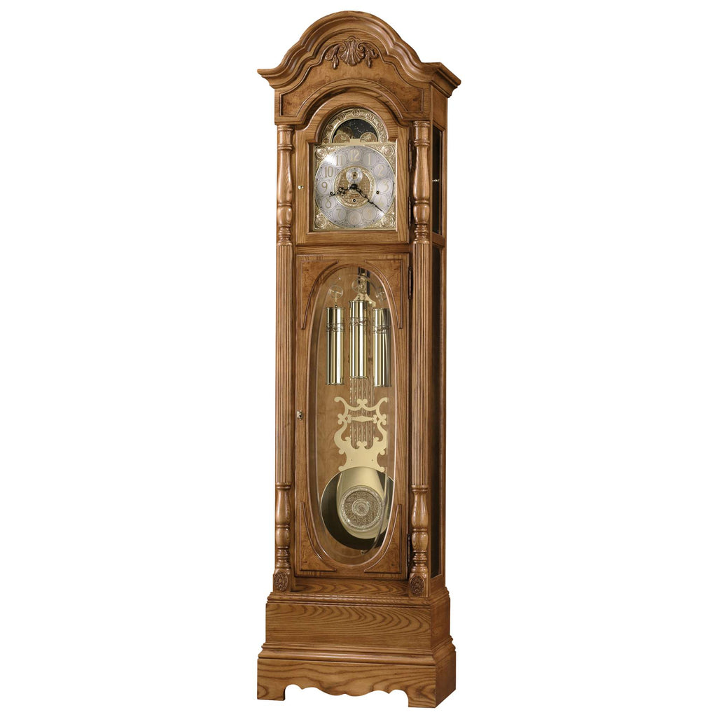 A tall wooden grandfather clock with a decorative design and glass panels.