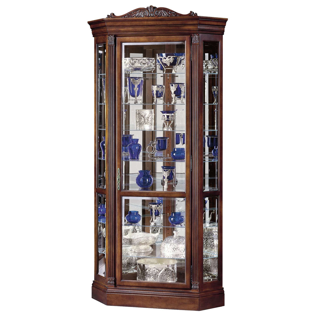 A tall, wooden display cabinet showcasing various blue and clear glass items.