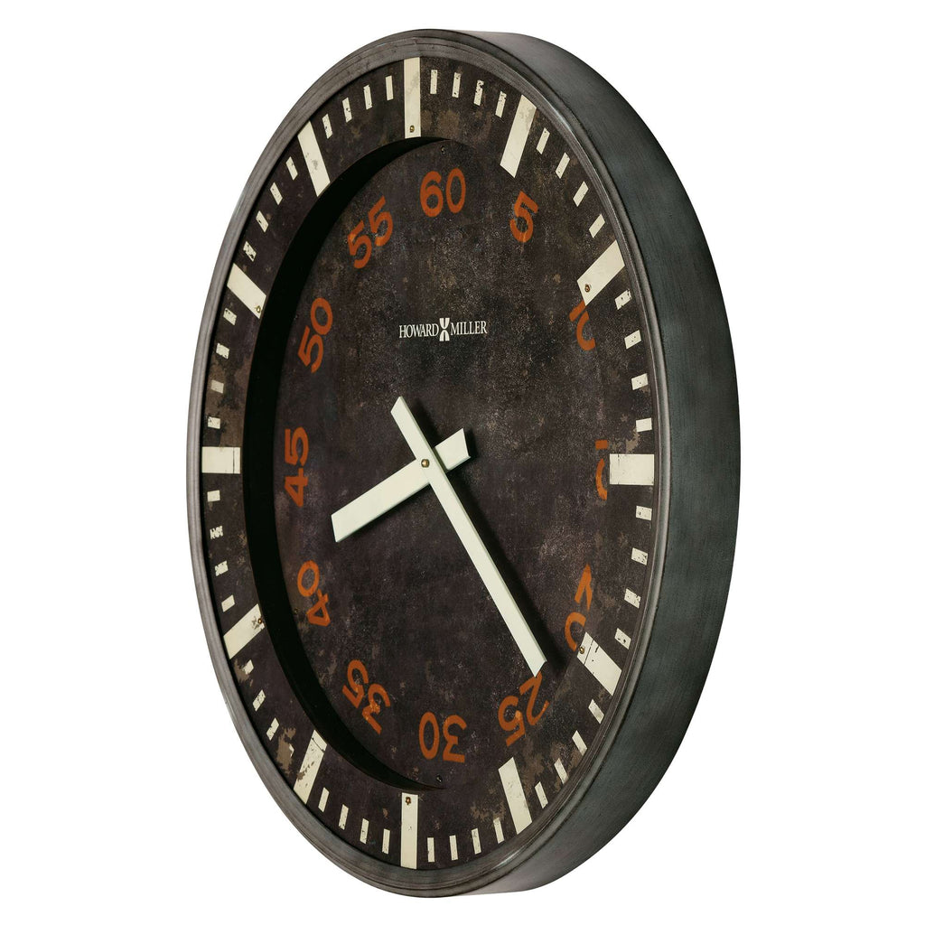 A large round wall clock with a black background and orange numbers.
