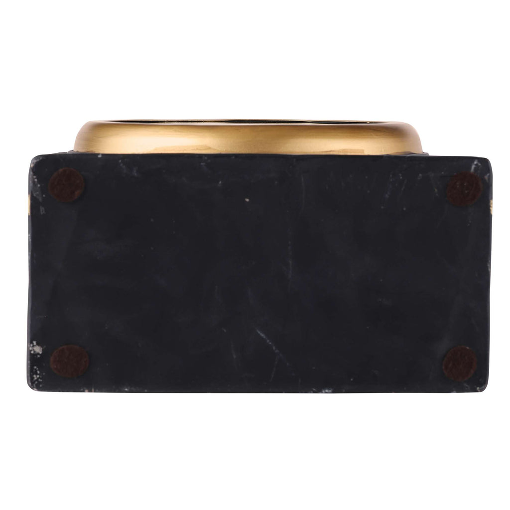 Bottom view of a decorative bowl with a gold rim and a black base.