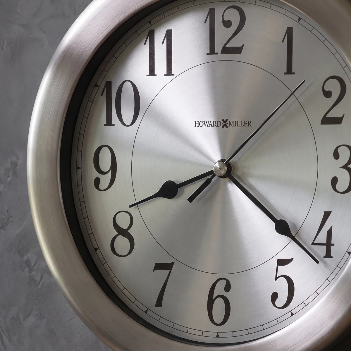 Howard Miller Pisces Wall Clock, close-up of the dial and finish detail