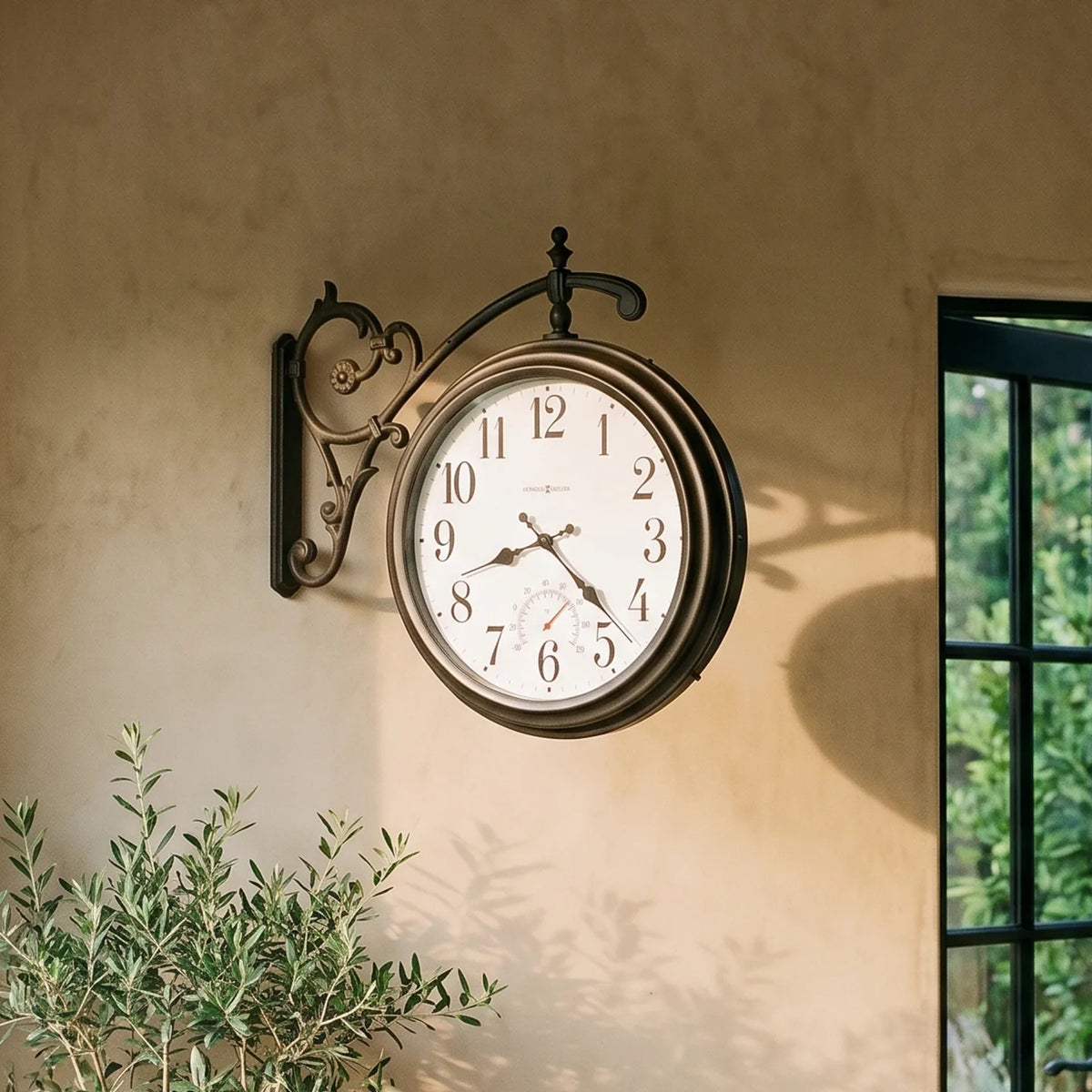 Howard Miller Luis Indoor/Outdoor Wall Clock, 22-inch, on the wall in a styled room