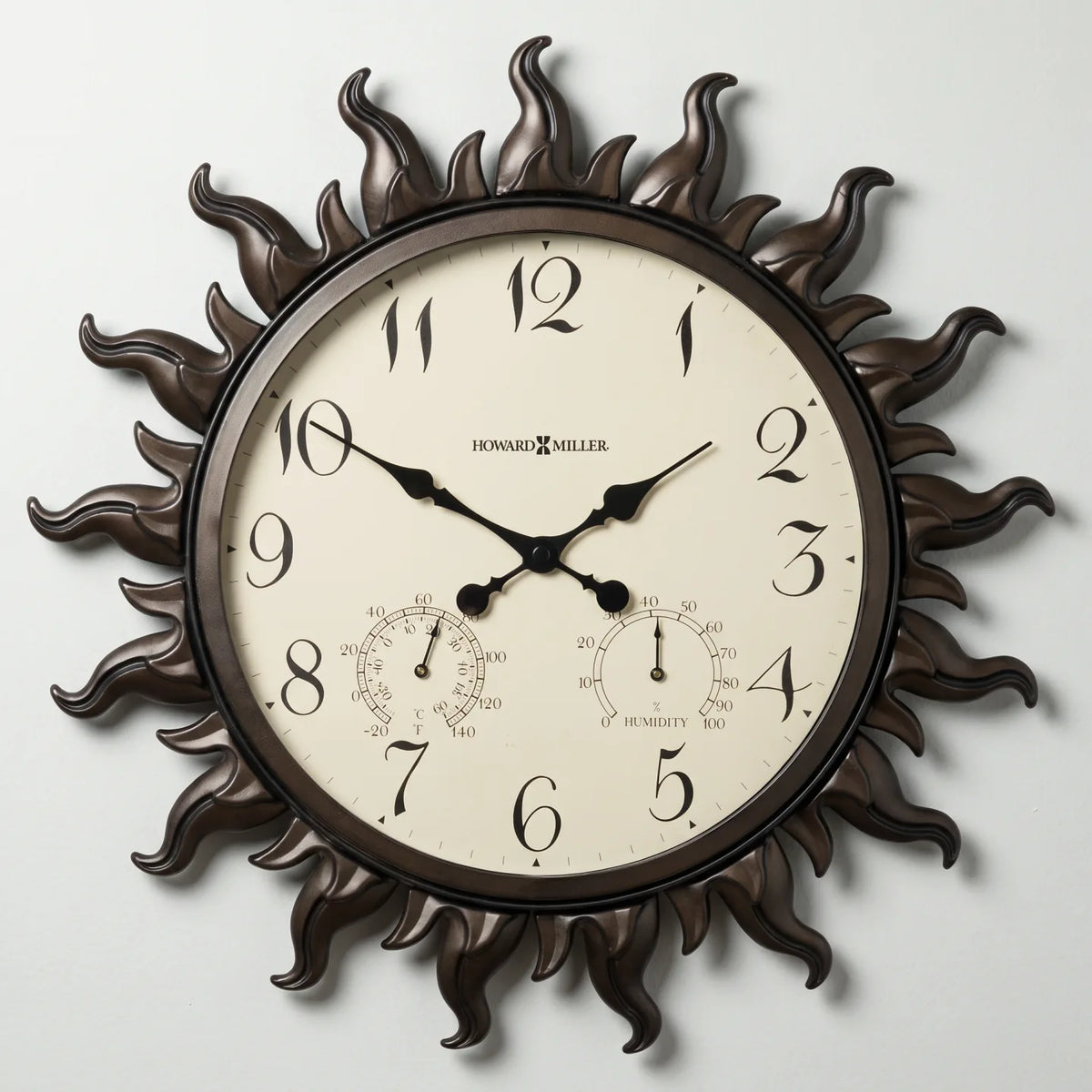 Howard Miller Sunburst II Indoor/Outdoor Wall Clock, 22-inch, front view on a plain white background