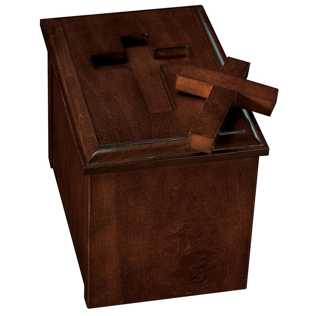 A wooden box with a cross on top and another cross resting beside it.
