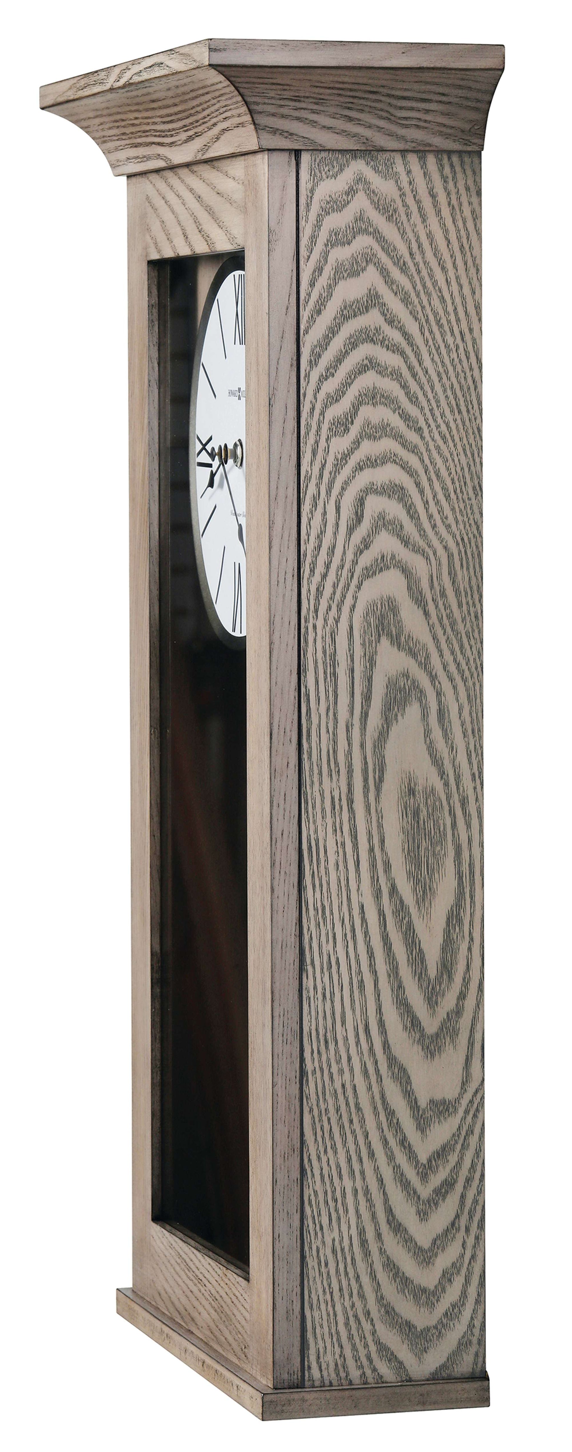 Side view of a tall wooden clock with a white face and Roman numerals.