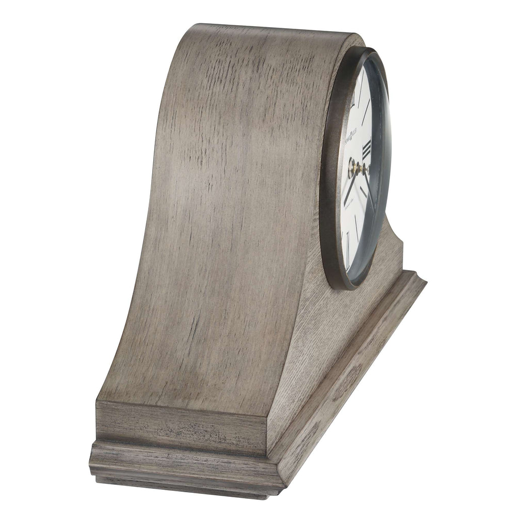A stylish antique clock with a curved wooden design.