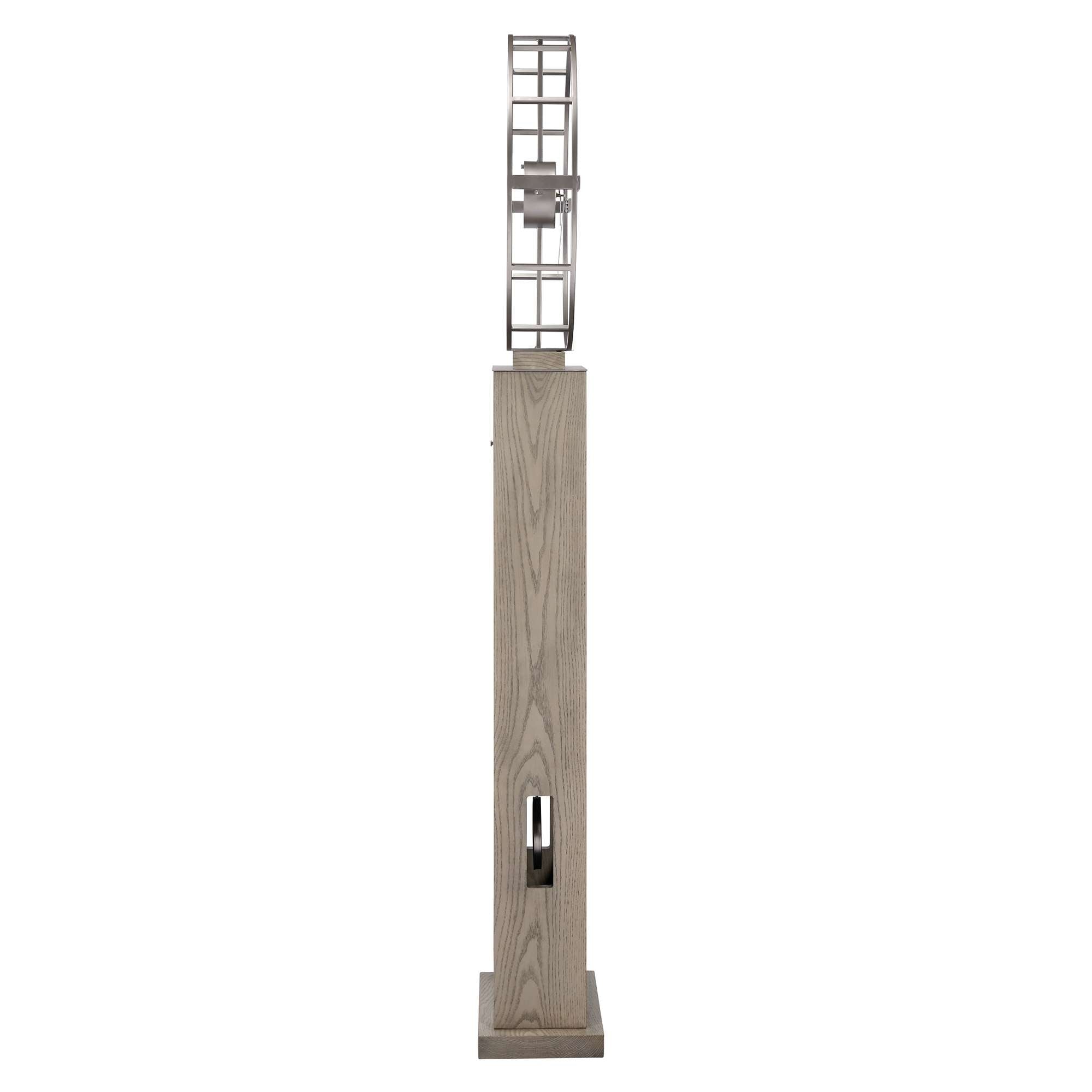 A tall, modern sculpture featuring a geometric metal design atop a wooden base.