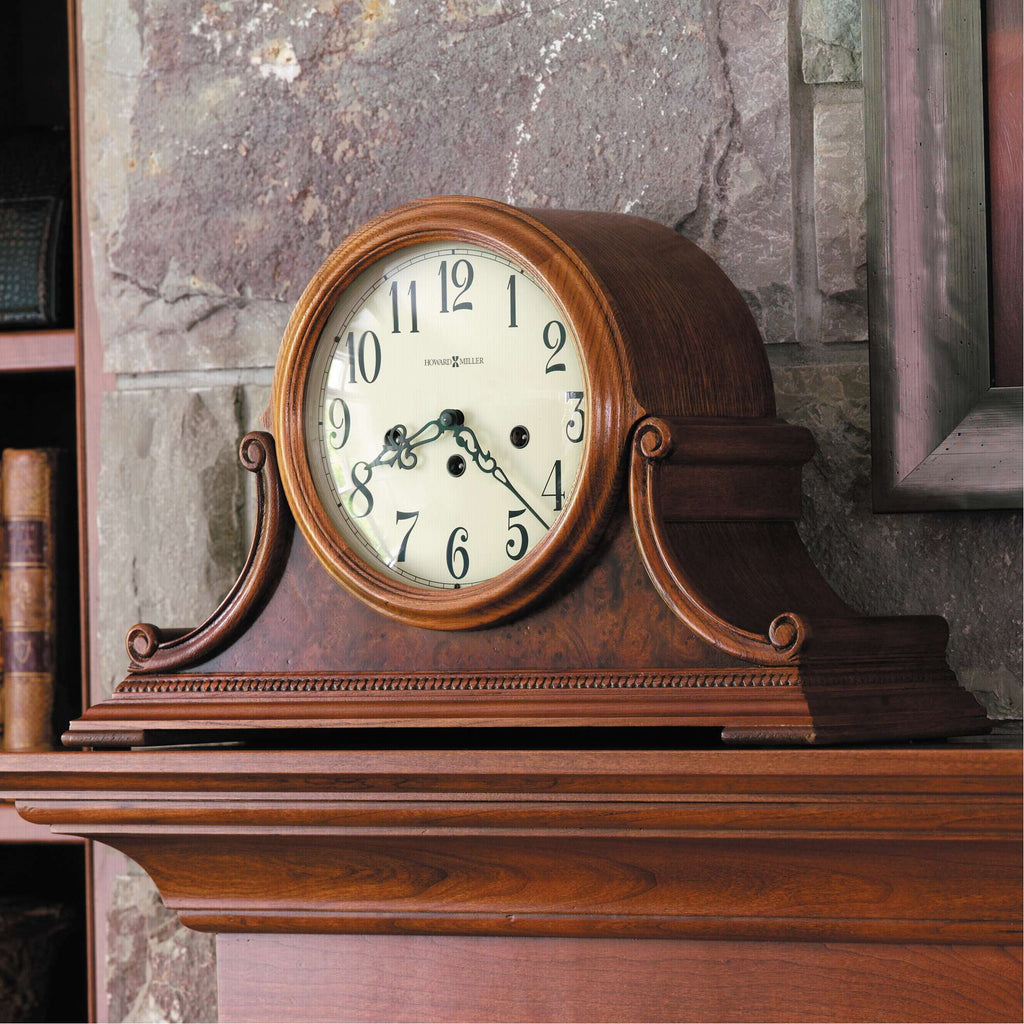 Antique wooden mantel clock on a stone fireplace.
