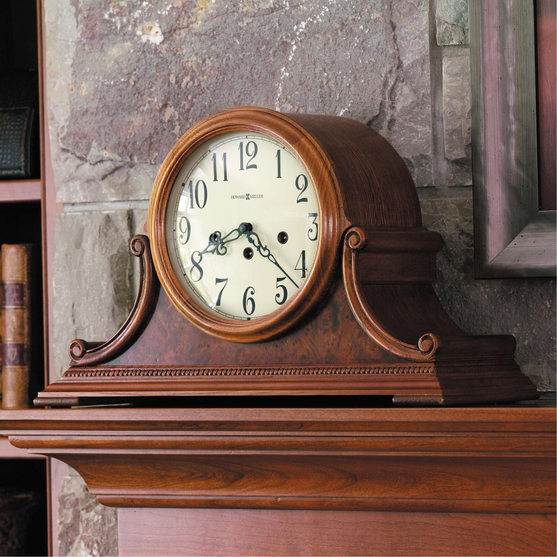 Antique wooden mantel clock on a stone fireplace.