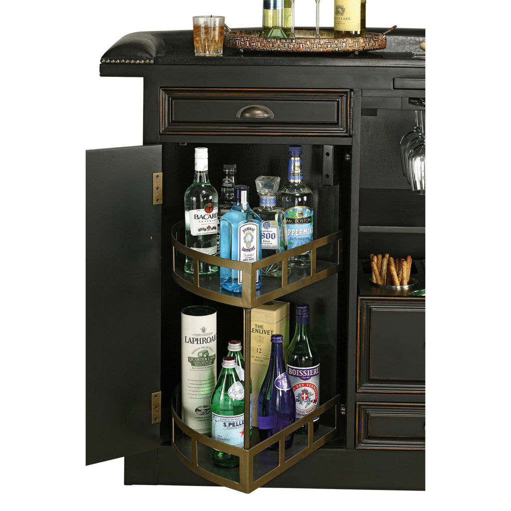 A home bar cabinet with bottles of various spirits and mixers organized on shelves inside.
