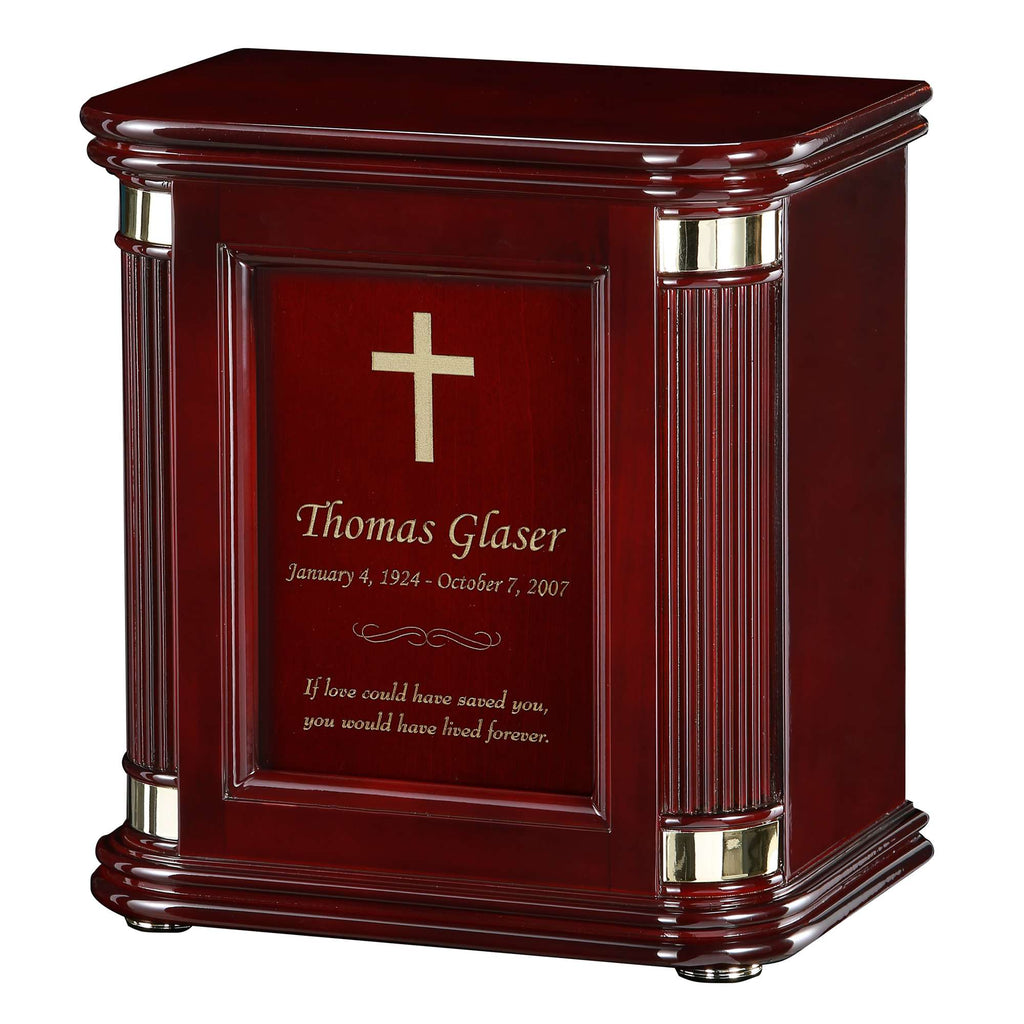 A wooden urn with a cross design and engraved memorial details.