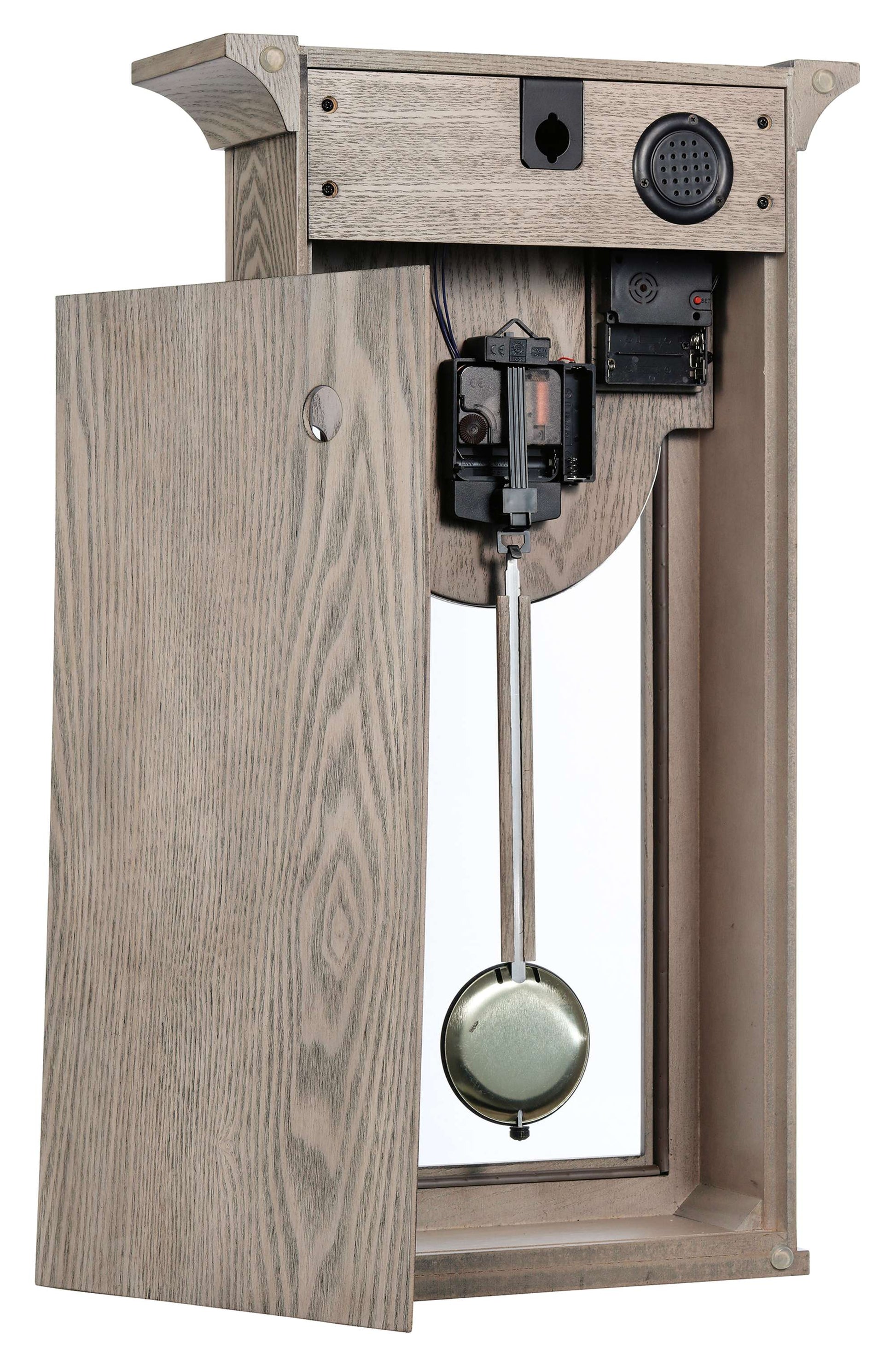 A vintage-style wall-mounted mechanical device with a door, mirror, and a pendulum-like mechanism inside.