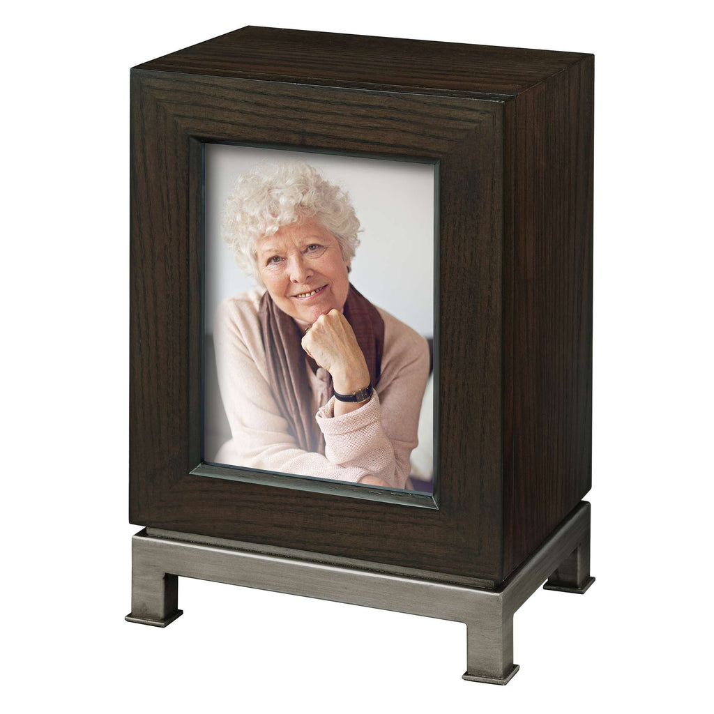 A photo frame displaying an image of a smiling older woman with curly hair.