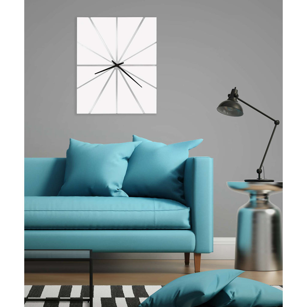 Modern living room with a turquoise sofa, decorative pillows, a wall clock, and a stylish lamp.