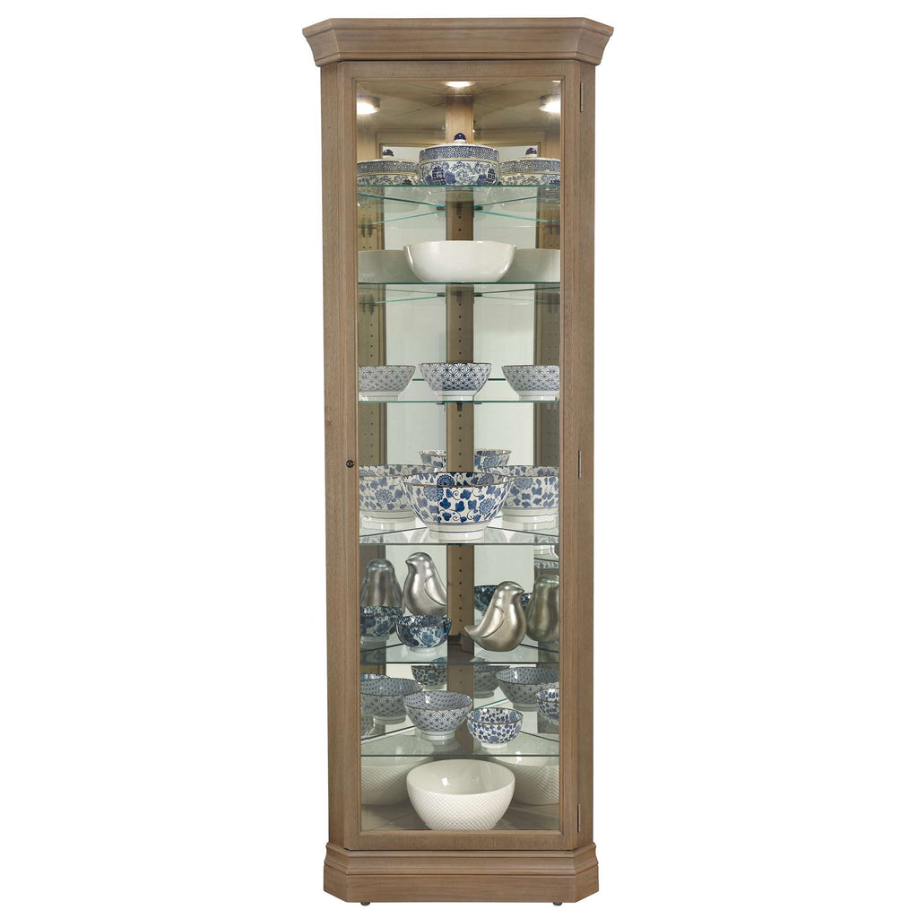 A tall wooden display cabinet showcasing various decorative bowls and dishes.