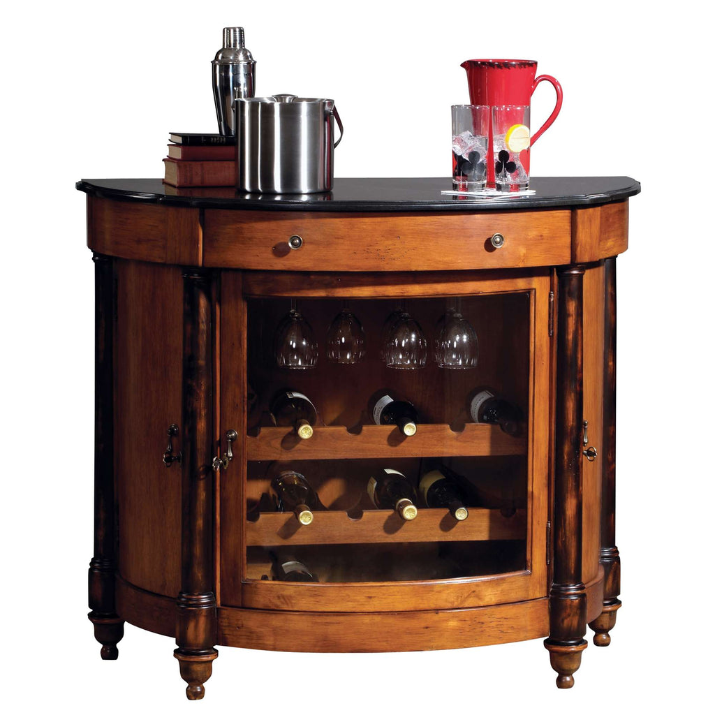 A wooden bar cabinet with a curved design, featuring a black top, glass front displaying wine bottles, and drinks on top.