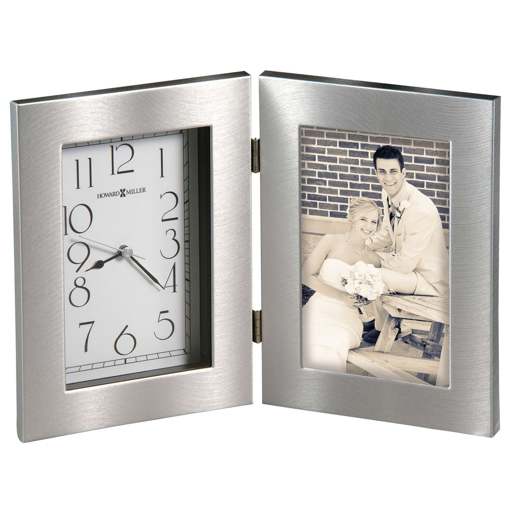 A silver-colored photo frame with a clock on one side and a picture of a couple on the other side.