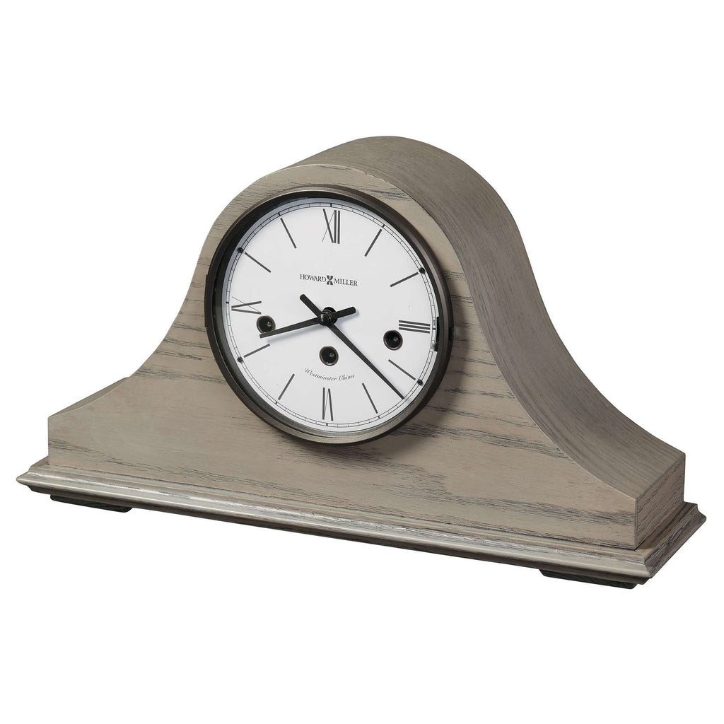 A stylish, modern mantel clock with a white face and wooden base.