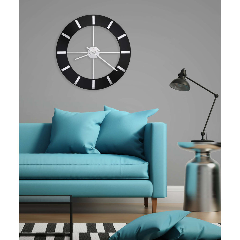 Modern living room with a light blue sofa, decorative pillows, and a wall clock.