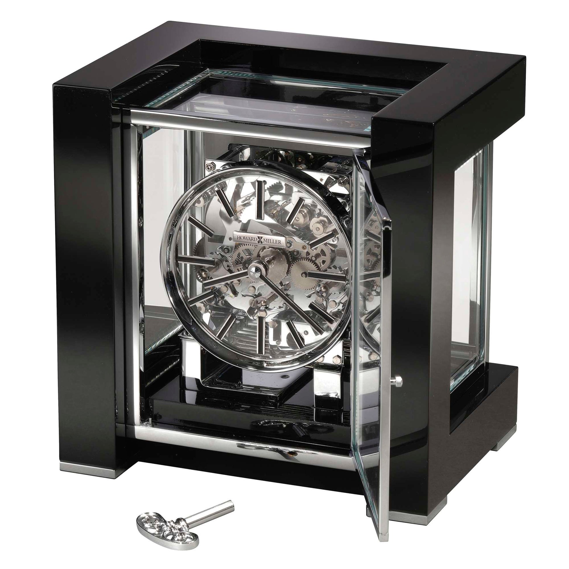 A stylish black and silver tabletop clock with a transparent glass case and intricate gear design.