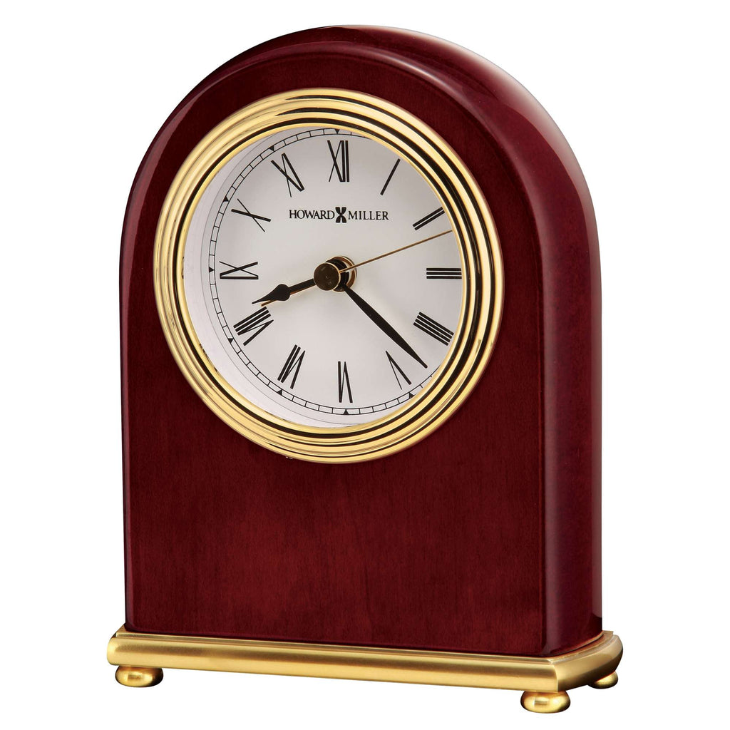 A classic wooden mantel clock with gold accents and Roman numerals.
