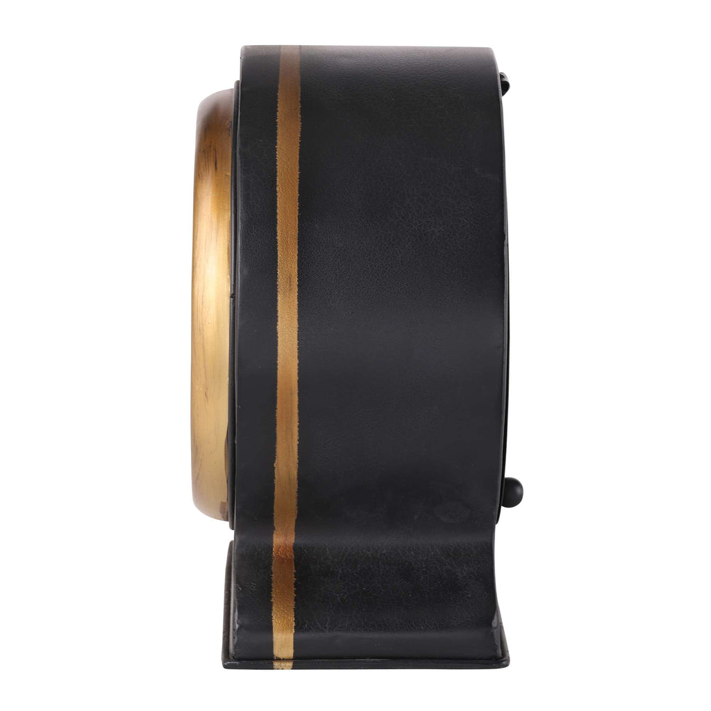 Profile view of a black and gold decorative clock.
