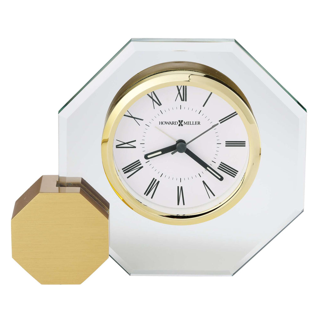 A decorative octagonal clock with a gold and white face, accompanied by a matching octagonal base.