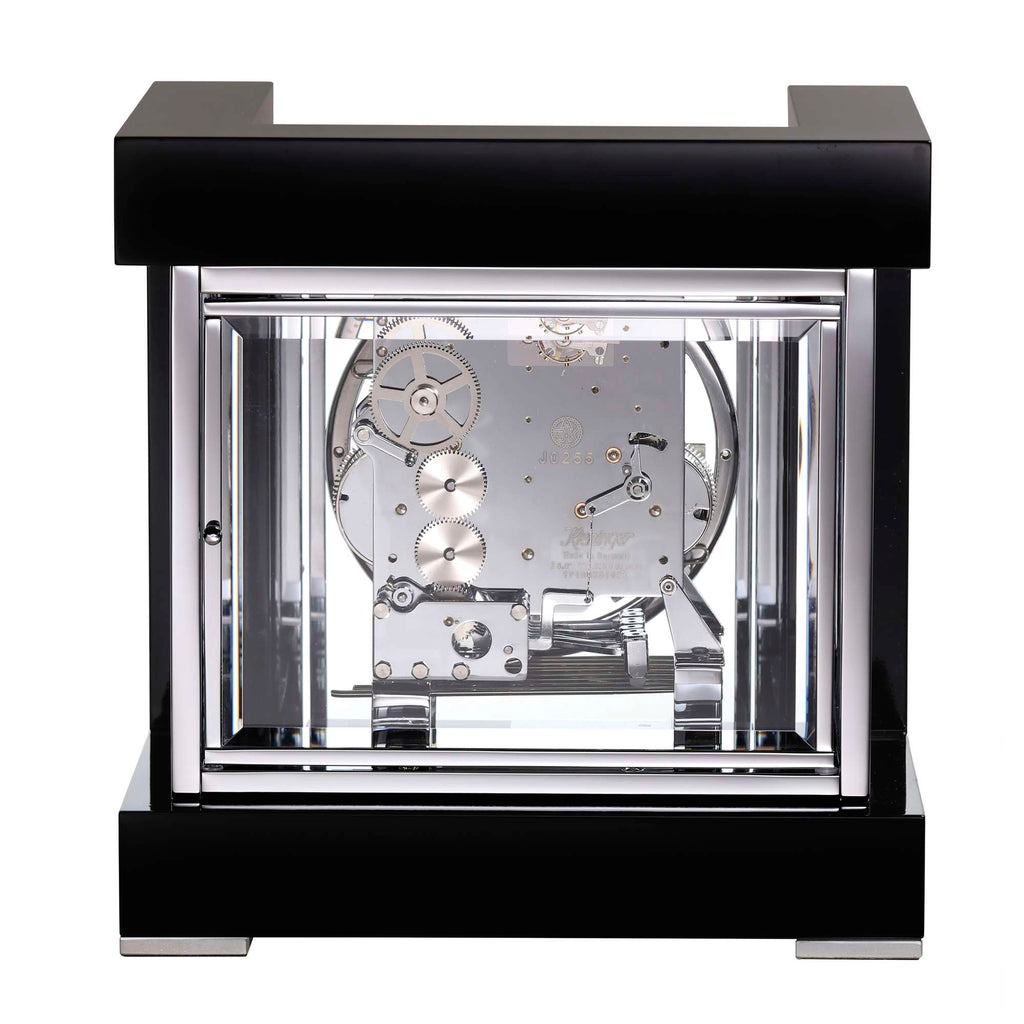 Close-up of a modern transparent clock showing intricate gears and mechanisms