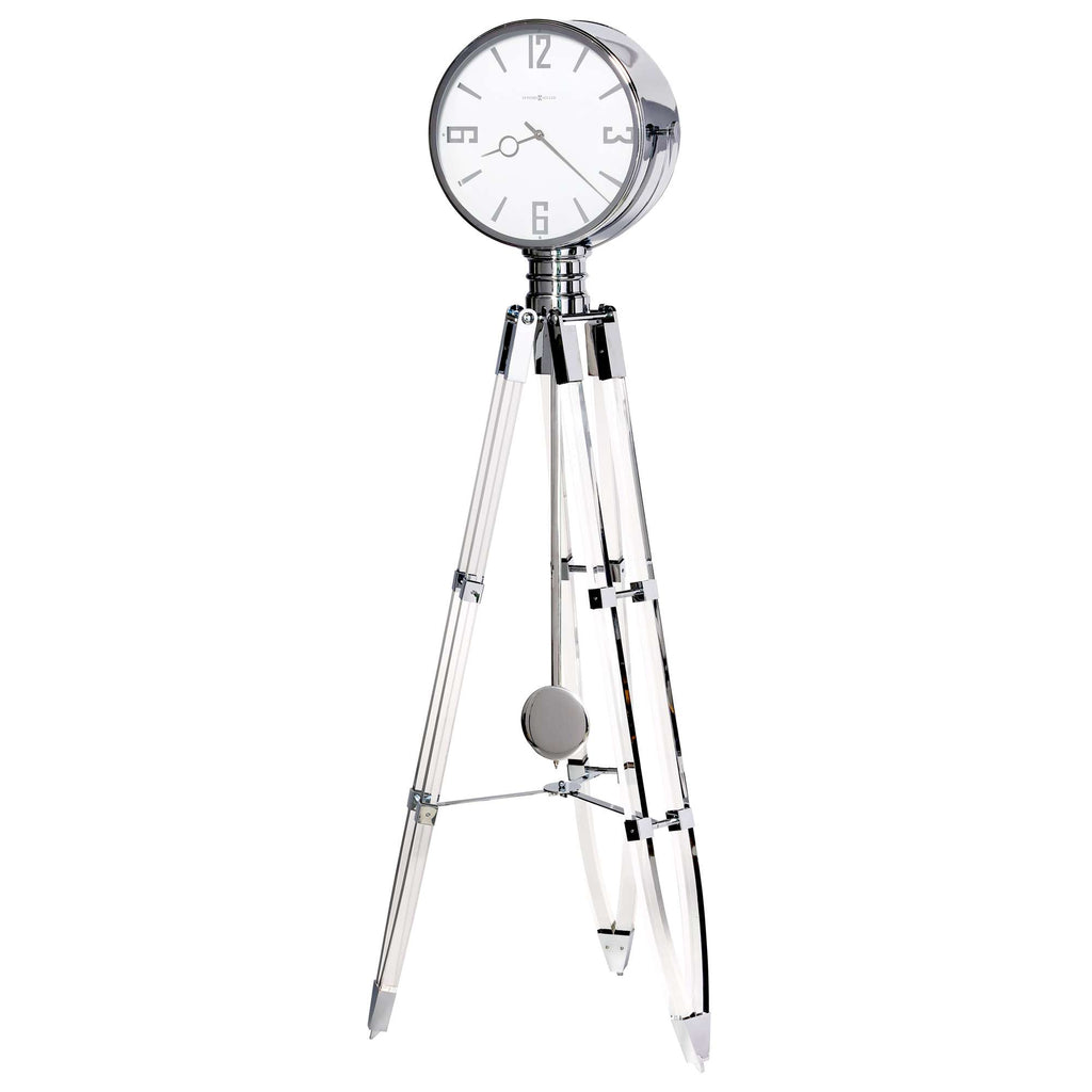 A stylish tripod floor clock with a chrome finish and round white clock face.