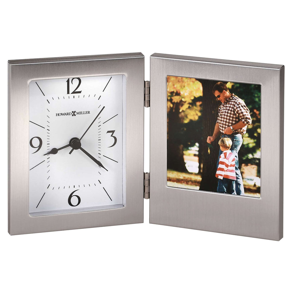 A silver picture frame with a clock on one side and a photo slot on the other.