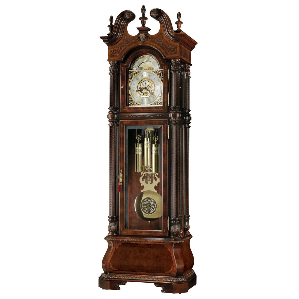 An ornate wooden grandfather clock with a glass front showcasing its pendulum and clock face.
