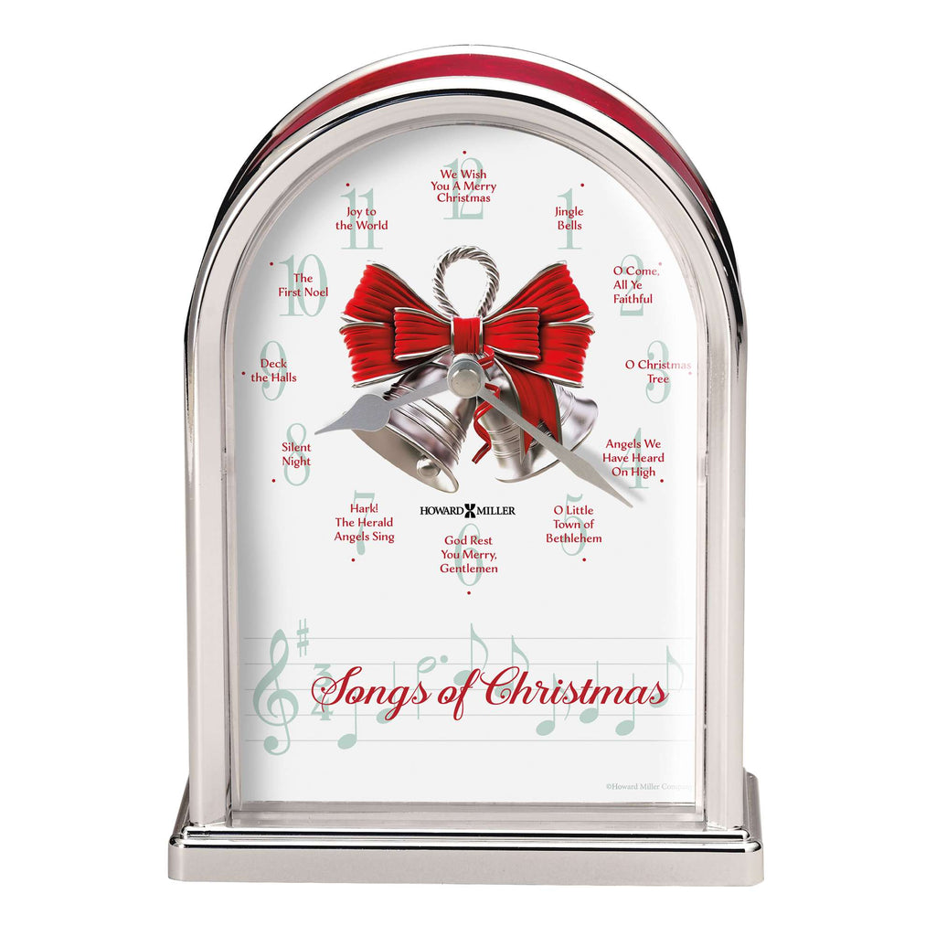 A decorative music box featuring a silver bell and red bow with 'Songs of Christmas' written on it.